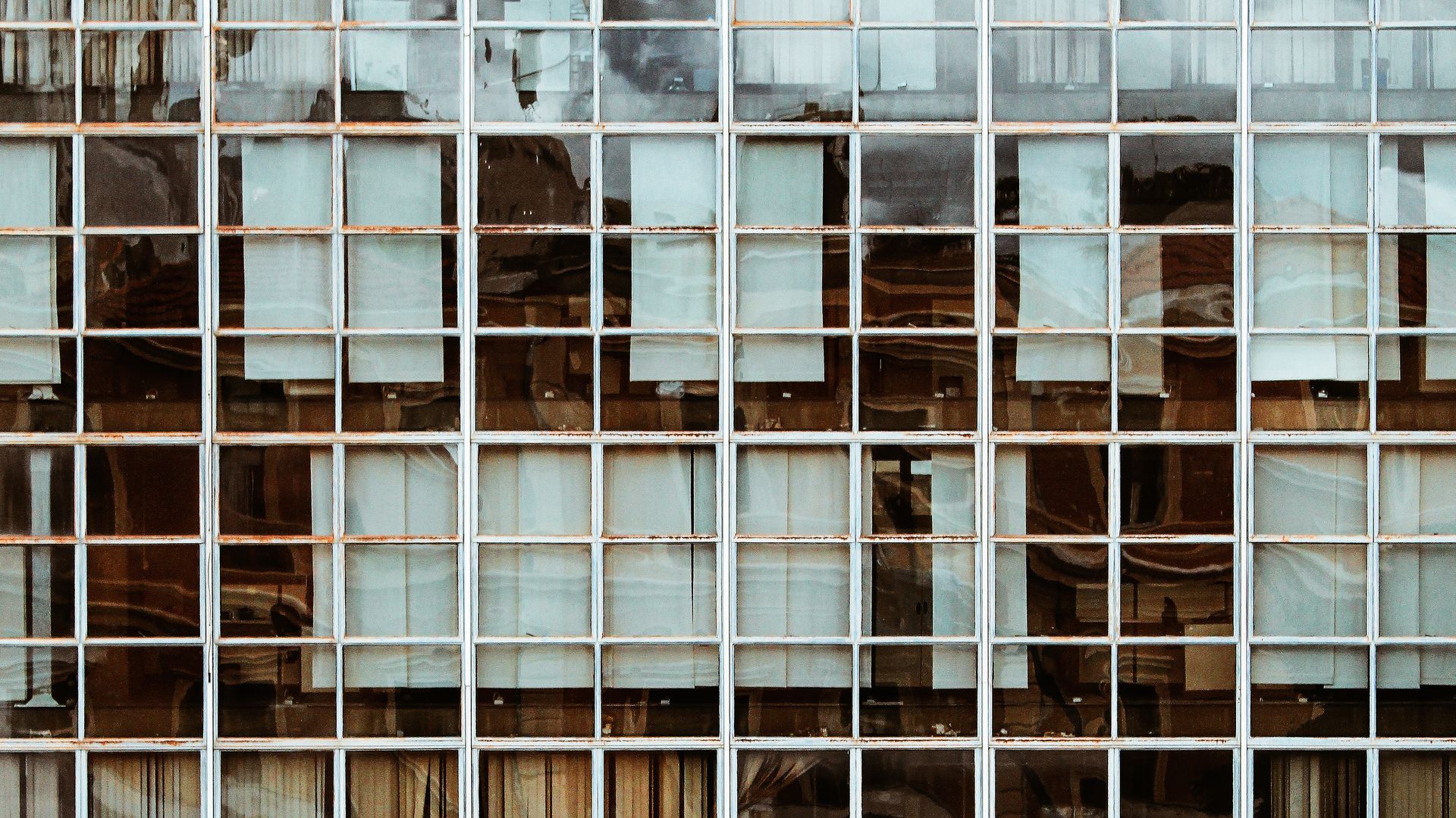 Reflektierende Glasfassade eines modernen Bürogebäudes.